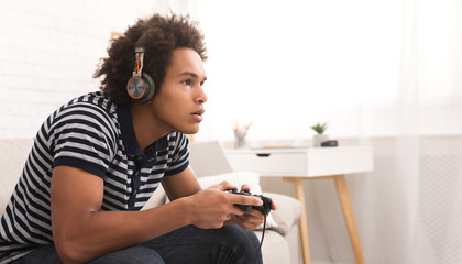 Poster - concentrated teenager playing video games with joystick