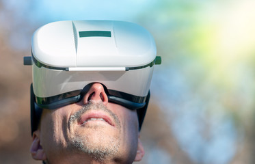 Mesmerized man wearing VR glasses exploring city park in winter