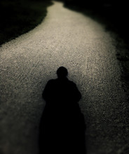 Creepy Solitary Silhouette On Long Winding Path.