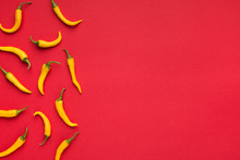 Hot Yellow Chilli Peppers On Red Background