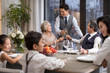 © Blue Jean Images - Noble family eating holiday meal together
