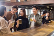 © Blue Jean Images - Happy friends drinking beer and talking in bar