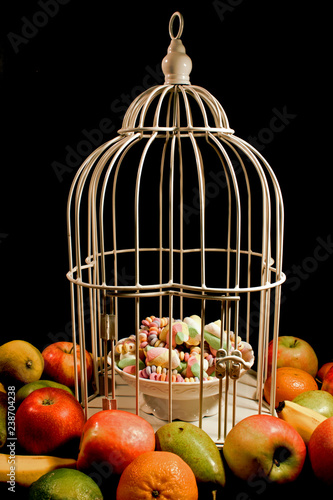 Fruits surrounding a cage with sweets enclosed. - Buy this stock ...