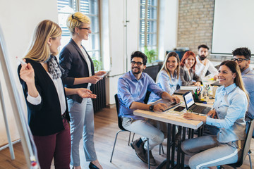 Business colleagues in conference meeting room during presentation