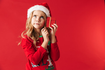 Wall Mural - Pensive little girl wearing Christmas costume