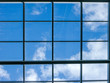© evgenfagot - Blue sky with white clouds through the window in the ceiling of a large building
