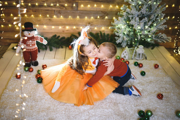 Wall Mural - brothr kissing sister among christmas balls