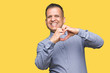 © Krakenimages.com - Middle age arab business man over isolated background smiling in love showing heart symbol and shape with hands. Romantic concept.