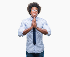 Canvas Print - Afro american business man wearing glasses over isolated background praying with hands together asking for forgiveness smiling confident.