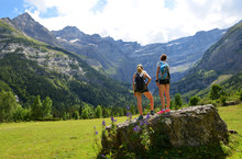 Two Tourist In The Pyrenees Mountain. Cirque De Gavarnie, France.