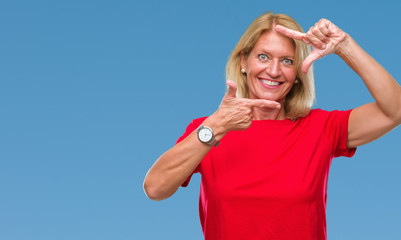 Canvas Print - Middle age blonde woman over isolated background smiling making frame with hands and fingers with happy face. Creativity and photography concept.