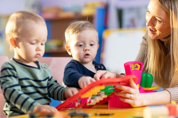 two kids play role game in toy shop at home or kindergarten