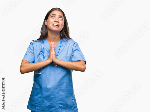 Young Arab Doctor Surgeon Woman Over Isolated Background Begging And Praying With Hands Together With Hope Expression On Face Very Emotional And Worried Asking For Forgiveness Religion Concept Stock Photo Adobe