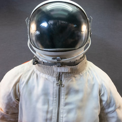 Wall Mural - White astronaut or spaceman suit and helmet on grey background