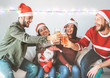© Alessandro Biascioli - Group of happy friends cheering with beer at christmas party - Young people having fun drinking and enjoying together xmas holidays - Friendship, drinks and youth celebrating lifestyle concept