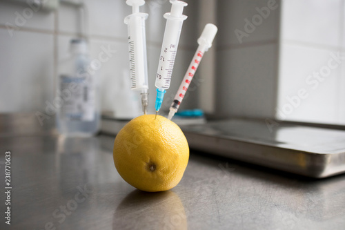 Fotografia Getting your dose of vitamins from fruits, food and supplements, syringes stuck