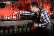 © JackF - man worker examining colorants for leather in leather workshop