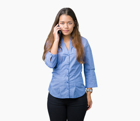 Canvas Print - Young beautiful brunette business woman talking on smartphone over isolated background with a confident expression on smart face thinking serious