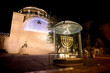 Menorah - the golden seven-barrel lamp - the national and religious Jewish emblem near the Dung Gates on the background of the synagogue Hurva at night in the Old City of Jerusalem, Israel
