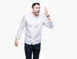 © Krakenimages.com - Young business man over isolated background shouting and screaming loud to side with hand on mouth. Communication concept.