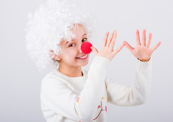 Wall Mural - Pretty teen girl in white clown wig and red nose gesturing with hands