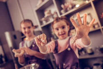 Wall Mural - Selective focus of a hand in the dough