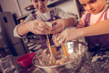 Wall Mural - Selective focus of eggs being added to the dough