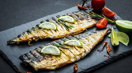 Sticker - Fried mackerel fillets with lime on black slate board