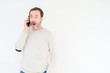 © Krakenimages.com - Senior man talking on smartphone over isolated background scared in shock with a surprise face, afraid and excited with fear expression