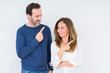 © Krakenimages.com - Beautiful middle age couple in love over isolated background cheerful with a smile of face pointing with hand and finger up to the side with happy and natural expression on face