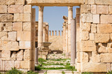 view to gate in wall to columns and ruins in Jerash city