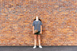 Girl looking up against brick wall background