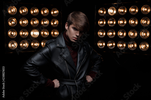 Young Man With A Haircut In A Leather Jacket In Retro Style In