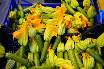 Wall Mural - Zucchini flower blossoms in a crate at an Italian farmers market