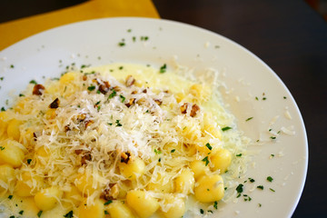 Wall Mural - Plate of Italian potato gnocchi with gorgonzola cheese and walnuts