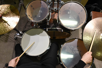  Professional drum set closeup. Man drummer with drumsticks playing drums and cymbals, on the live music rock concert or in recording studio   