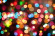 Colourful festive multi-colored circles . Defocused abstract multicolored bokeh lights background.Rainbow bokeh effect.Holiday postcard.Festive Winter wallpaper background.