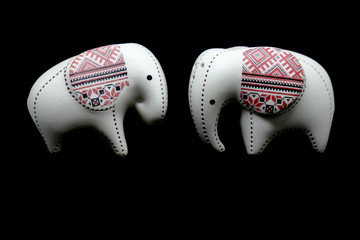 Wall Mural - Small ceramic elephant  isolated on black background.