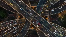 Abstract Low Angle Drone Shot Of Traffic Driving Over A Busy Intersection, A Convergence Of Roads In Central Shanghai City, China