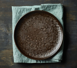 Dark empty plate on wood table