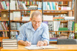 © Ermolaev Alexandr - elderly man preparing for exams in the library