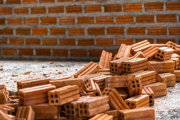 Wall Mural - Stack of Brick preparing for mansonry over the photo blurred of Bricks wall background,