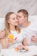 © Ermolaev Alexandr - Romantic happy couple having breakfast in bed