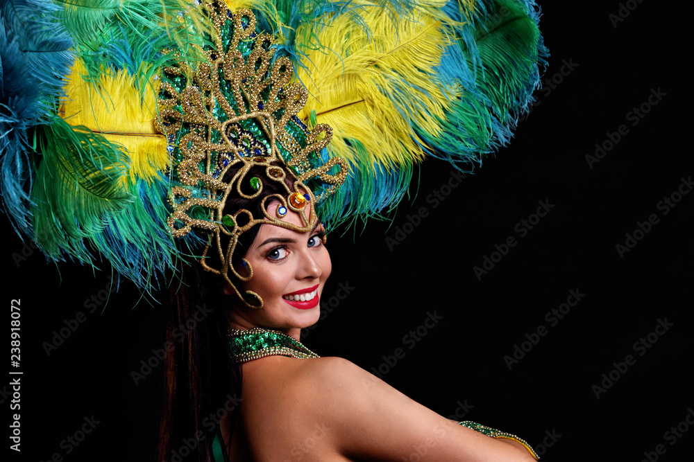 Brazilian woman posing in samba costume over black background - obrazy, fototapety, plakaty 