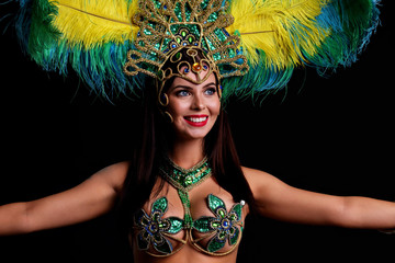 Wall Mural - Brazilian woman posing in samba costume over black background