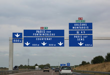 Big Road Signs On The Busy French Highway To Go To Paris