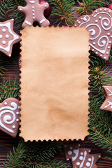 Poster - Blank paper sheet, gingerbread cookies and spruce tree on wooden table