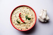 Nariyal or Coconut Chutney served in a bowl. Isolated over moody background. selective focus
