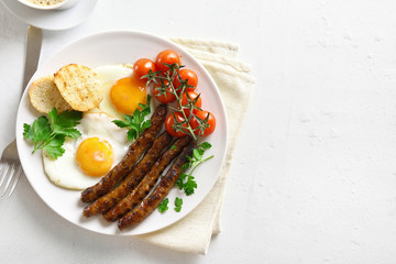 Canvas Print - Fried eggs, sausages and cherry tomatoes