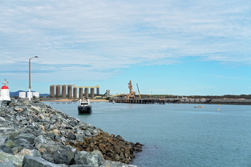 Tug Boat In An Industrial Export Harbor